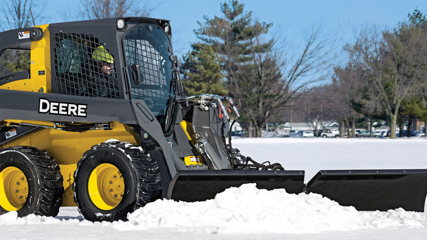 Snow Pusher Attachment on John Deere Skid Steer moving snow